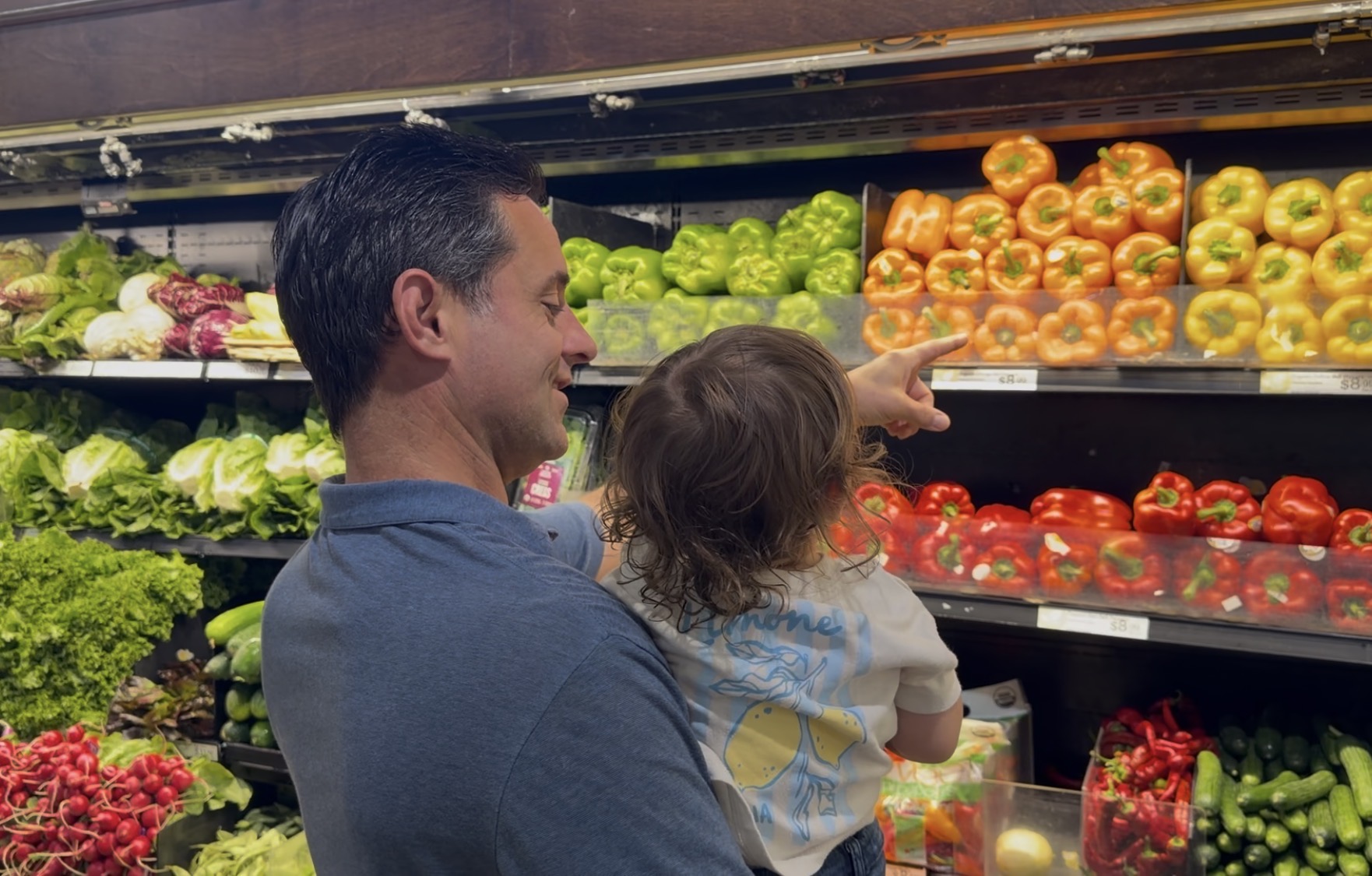 Ryan and his daughter picking out peppers at the Co-op